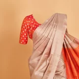 Nude Beige Kanjeevaram Saree with contrasting Tangerine Orange Blouse